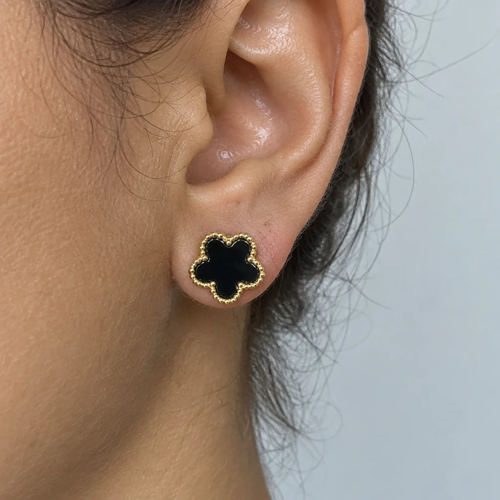 Tightly recrop the attached photo to a square close-up showing only the person's ear and the black f